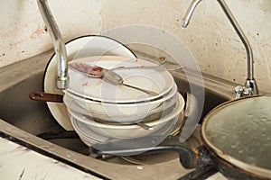 Lot of dirty dishes in the old kitchen