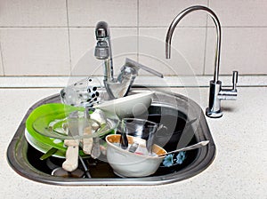 A lot of dirty dishes in the sink