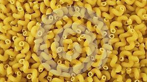 A lot of dry pasta as spirals shape. Popular Italian and European cuisine. Food background. Top view. Top down food. Flat lay.