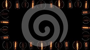 A lot of Edison bulbs creating great background for logo or title. Blinking lamps black background isolated. Vintage