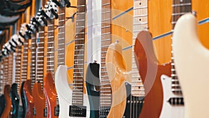 Lot of electric guitars hanging in a music store. Shop musical instruments