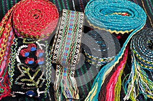 Lot of embroidered belts photo