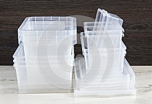 Lot of empty clear plastic storage boxes stacked. Ready for home organizing sorting concept.
