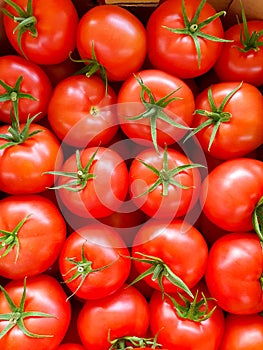 a lot of evenly stacked beautiful ripe bright red cherry tomatoes