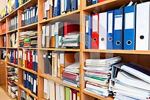 A lot of files folder store in the office shelf: papers, documents and catalogs