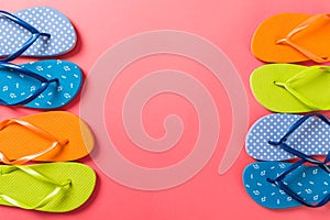 A lot of flip flop colored sandals, summer vacation on colored background, copy space top view