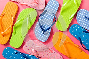 A lot of flip flop colored sandals, summer vacation on colored background, copy space top view