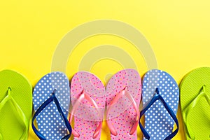 A lot of flip flop colored sandals, summer vacation on colored background, copy space top view