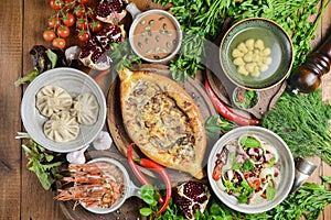 A lot of food on the wooden table. Georgian cuisine. Top view, flat lay