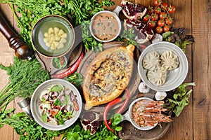 A lot of food on the wooden table. Georgian cuisine. Top view, flat lay