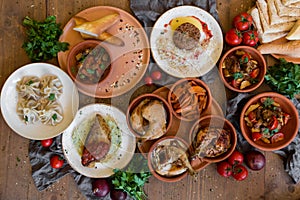 A lot of food on the wooden table. Georgian cuisine. Top view. Flat lay . Khinkali and Georgian dishes