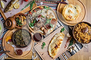 A lot of food on the wooden table. Georgian cuisine. Top view. Flat lay . Khinkali and Georgian dishes