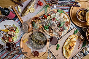 A lot of food on the wooden table. Georgian cuisine. Top view. Flat lay . Khinkali and Georgian dishes