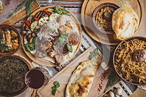 A lot of food on the wooden table. Georgian cuisine. Top view. Flat lay . Khinkali and Georgian dishes