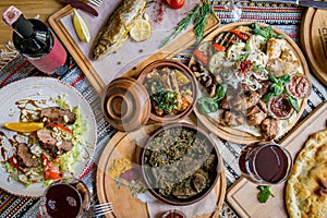 A lot of food on the wooden table. Georgian cuisine. Top view. Flat lay . Khinkali and Georgian dishes