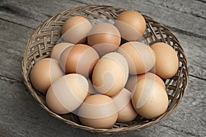 A lot of fresh eggs in basket on wooden.