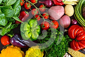 A lot of fresh organic vegetables on a wooden background.