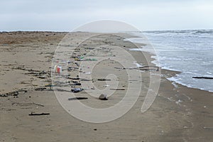 A lot of garbage on the sandy seashore. World environmental problems