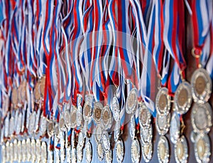 A lot of gold medals with ribbons