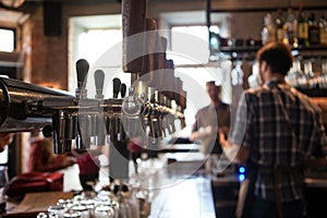 A lot of Golden beer taps at the bar