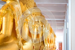 A Lot of Golden Statue of Buddha sitting meditated  in the row at Thailand Temple