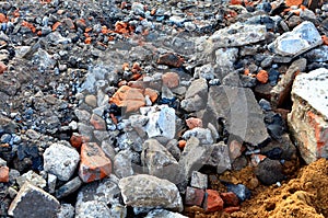 A lot of granite cobblestones on the ground or broken road, fragments of bricks, can be used as a background or texture