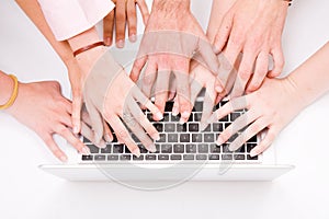 Lot of hands with grey laptop