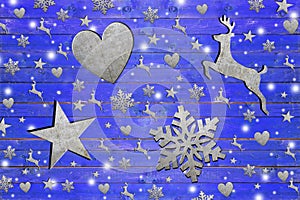 Lot of iron star, heart, dear and snowflake on weathered blue wooden board