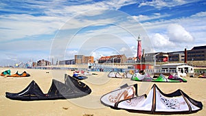 A lot of kiteboarding kites on the beach.