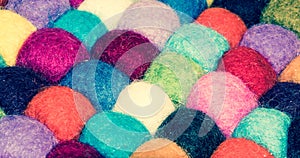 A lot of multi-colored balls of cotton for knitting close-up. Colored skeins of thread for needlework. Selective focus image