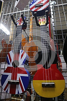 Multi-colored ukulele and guitars in a musical instrument store