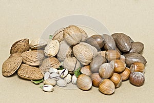 A lot of nuts on a brown background.