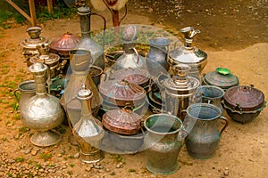 A lot of old copper utensils. Decorative jugs of old style metal