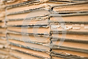 A lot of old, worn books are lying on top of each other.