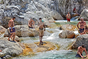 A lot of people bathing in a mountain stream canyon Kuzdere during jeep safari on the Taurus mountains.