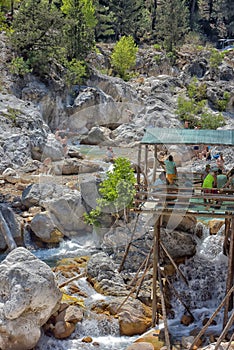 A lot of people bathing in a mountain stream canyon Kuzdere during jeep safari on the Taurus mountains.