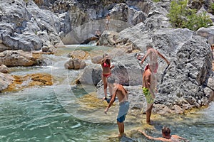 A lot of people bathing in a mountain stream canyon Kuzdere during jeep safari on the Taurus mountains.