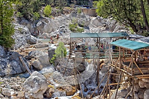 A lot of people bathing in a mountain stream canyon Kuzdere during jeep safari on the Taurus mountains.