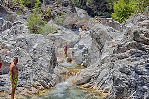 A lot of people bathing in a mountain stream canyon Kuzdere during jeep safari on the Taurus mountains.