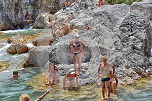 A lot of people bathing in a mountain stream canyon Kuzdere during jeep safari on the Taurus mountains.