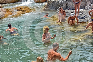 A lot of people bathing in a mountain stream canyon Kuzdere during jeep safari on the Taurus mountains.