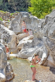 A lot of people bathing in a mountain stream canyon Kuzdere during jeep safari on the Taurus mountains.