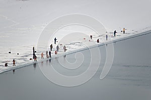 Lot of people fishing on the ice in winter