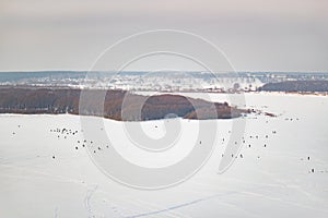 Lot of people fishing on the ice in winter