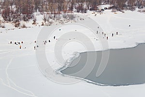 Lot of people fishing on the ice in winter