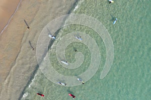 A Lot of People play and surf on Kata beach from Drone top view, a beautiful shot represent the relaxed vacation in Phuket