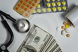 A lot of pills, a stethoscope and money on a table