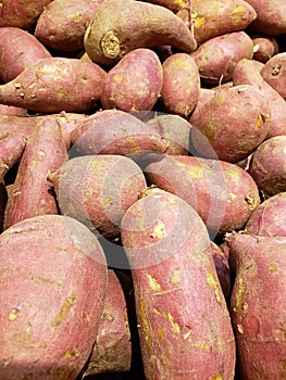 lot of pink camote in a market, background and texture photo