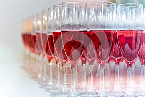 A lot of pink champagne glasses arranged on the table