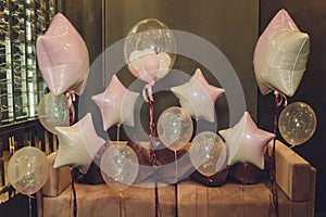 Lot of pink, white, shiny balloons in the form of heart, round, figure five, decoration of photon for birthday.